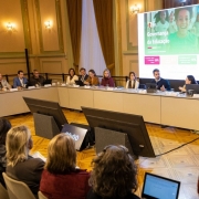 Grupo de trabalho reunido em torno de uma mesa de conferência no Palácio Piratini, com a presença do governador Eduardo Leite. Uma tela exibe a apresentação "Governança da Educação". Há laptops e microfones sobre a mesa.